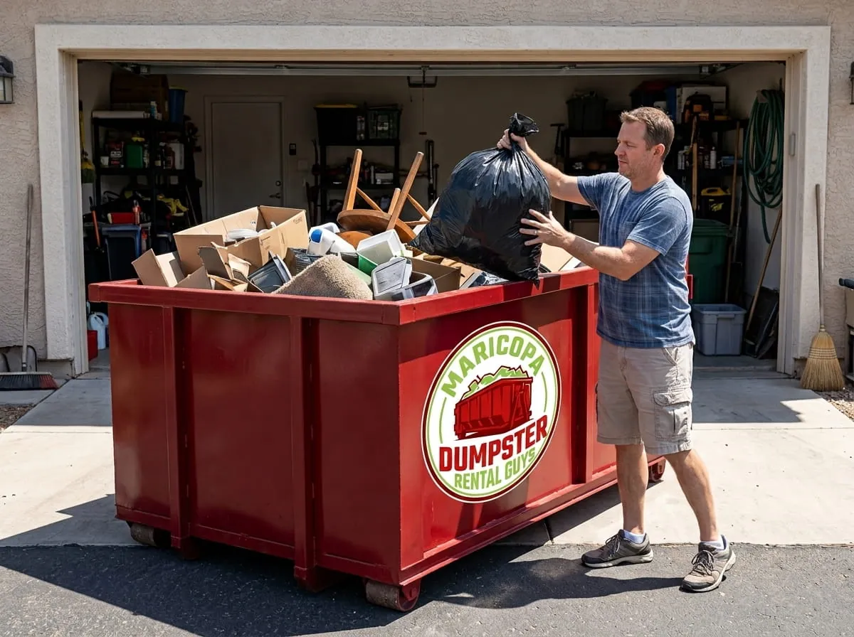 Homeowner loading household junk into a roll-off dumpster in Maricopa, Arizona